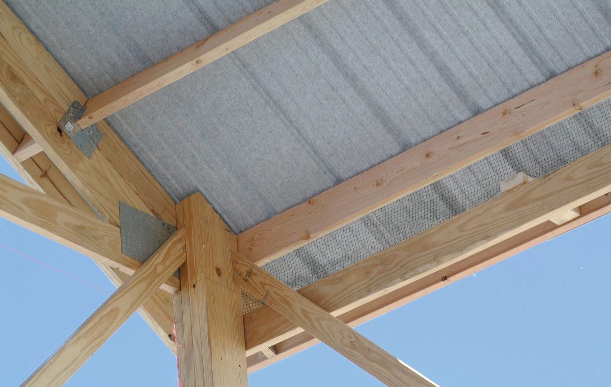 Grey roof lining resting on timber posts and beams